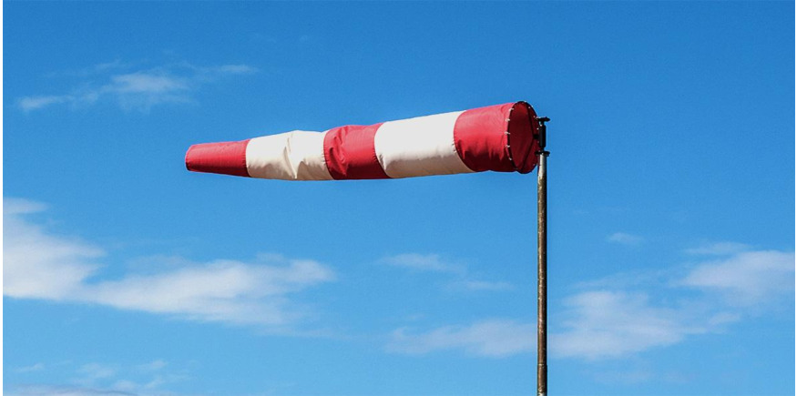 WIndsock blowing at beach indicating wind speed and direction
