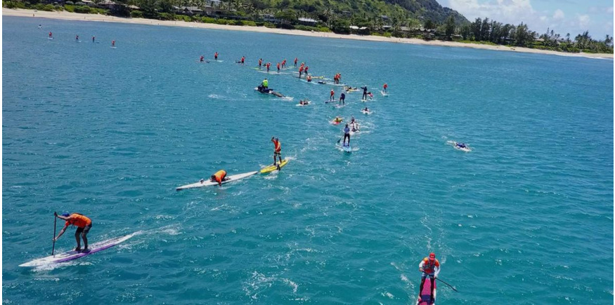 SUP paddlers negotiating bend on coastal racing course