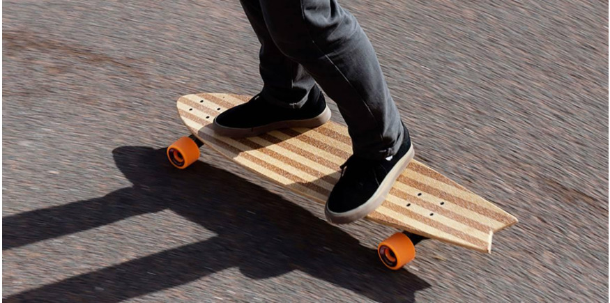 close up of skater riding bamboo longboard on the tarmac