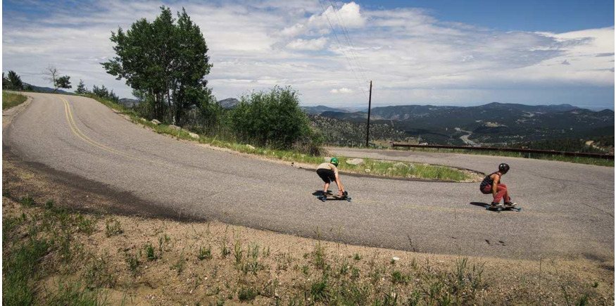 two longboarders riding downhill
