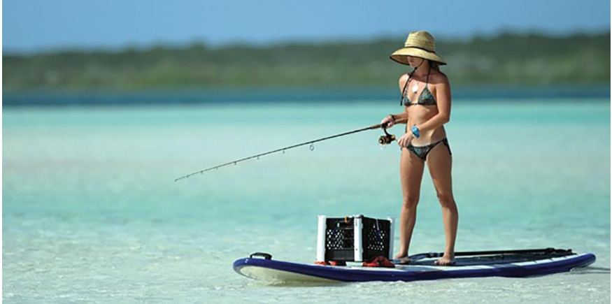 woman fishing from a paddleboard