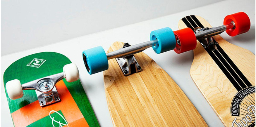 classic skateboard, pintail longboard and freeride longboard placed in the studio