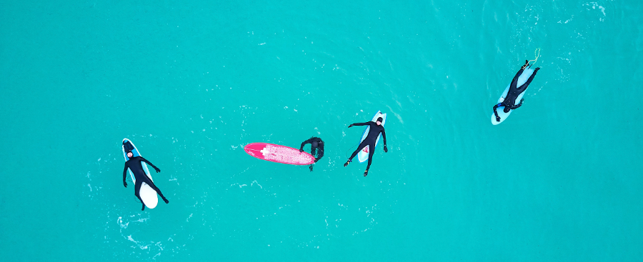 surfers relaxing in the ocean and sitting on boards