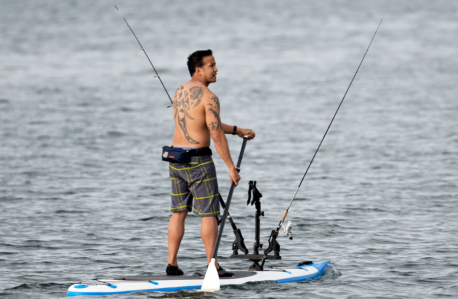 man fishing on stand up paddleboard