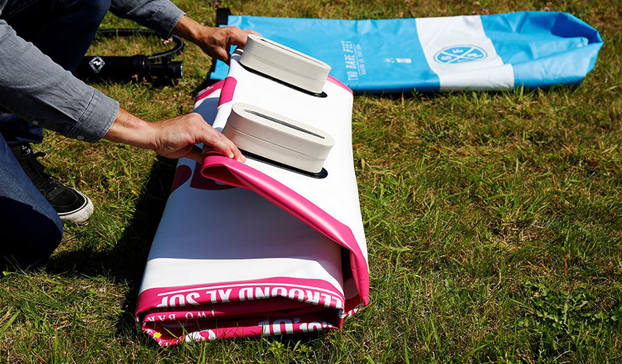 a rolled up inflatable SUP with fin protectors