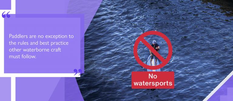 Paddleboarder paddling on prohibited river