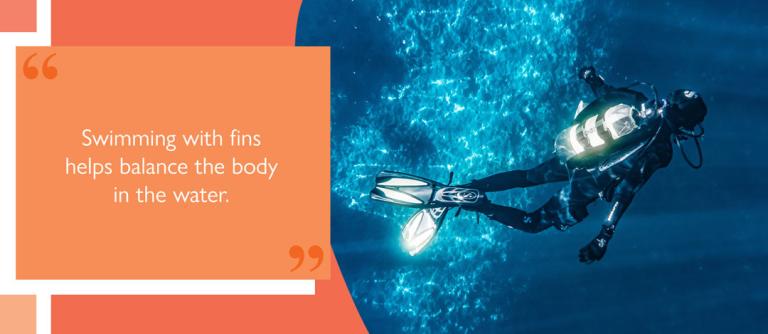 Aerial view of diver with air tank swimming underwater