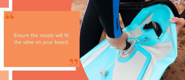 Paddler opening the inflation valve on a deflated iSUP