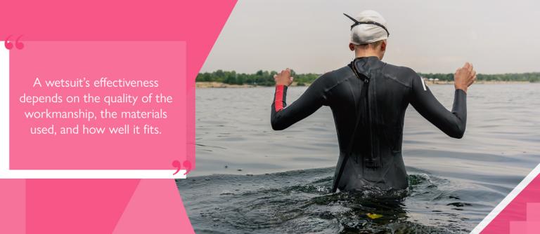 Paddler wearing full body wetsuit wading through water