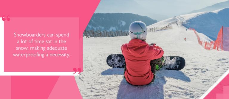 Snowboarder sat on slope wearing ski trousers