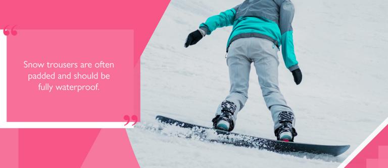 Snowboarder wearing snow trousers on downhill run