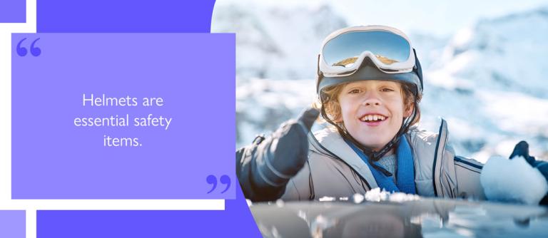 Child on snow wearing helmet and ski goggles