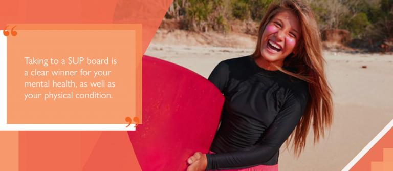 Happy paddleboarder benefitting from wellbeing aspects of SUP