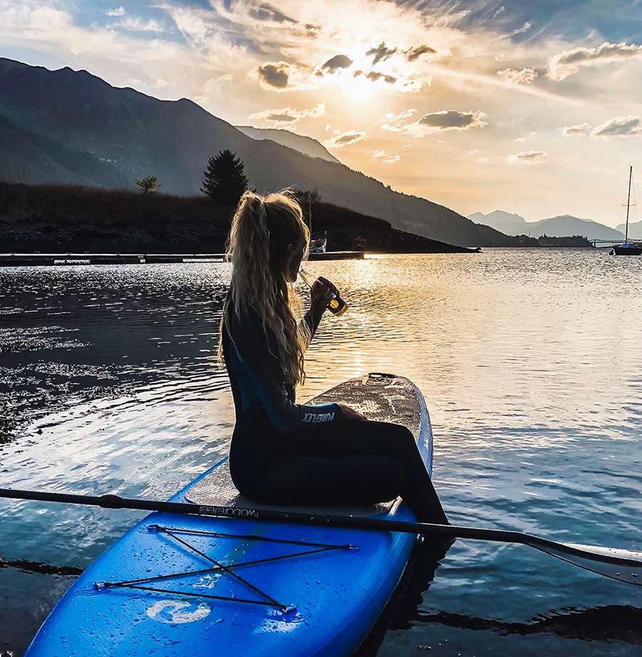 drinking a beer on a paddleboard