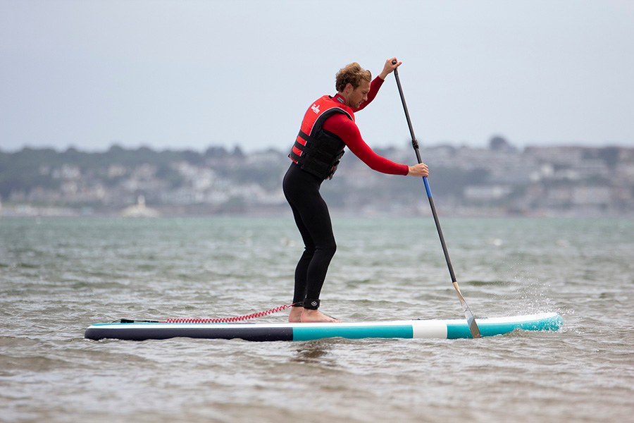 stand up paddleboarder on the sea
