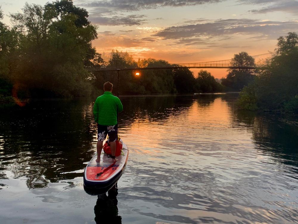paddleboarder on the river wye at sunrise